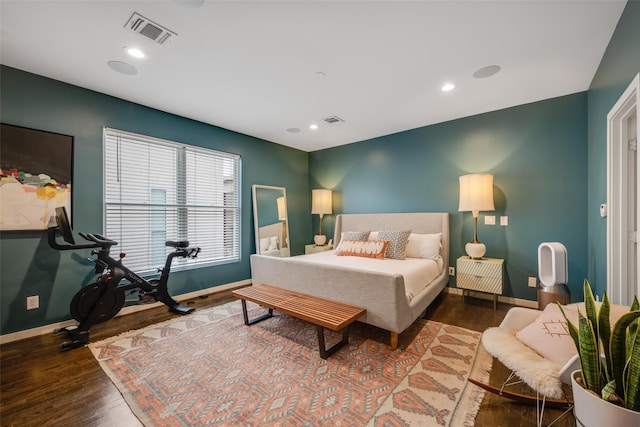 bedroom with baseboards, wood finished floors, and recessed lighting