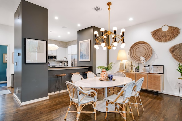 dining room with dark wood finished floors, a chandelier, recessed lighting, and baseboards
