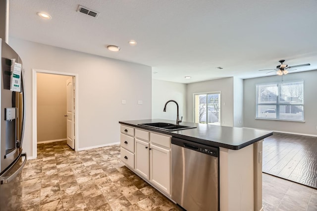 kitchen with sink, white cabinetry, an island with sink, ceiling fan, and stainless steel appliances