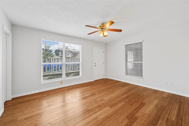 2305 Buckeye Dr, Mesquite, TX 75181 - empty room featuring a textured ceiling, ceiling fan, and wood finished floors