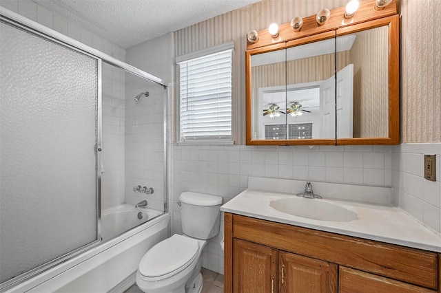 2305 Buckeye Dr, Mesquite, TX 75181 - bathroom featuring vanity, a textured ceiling, and combined bath / shower with glass door