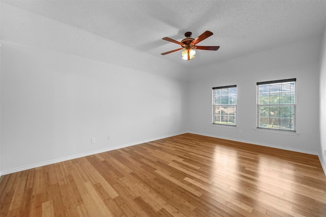 2305 Buckeye Dr, Mesquite, TX 75181 - empty room featuring light wood-style flooring, a ceiling fan, and a textured ceiling