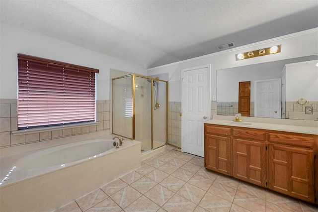 bathroom with vanity, separate shower and tub, tile patterned floors, and a textured ceiling