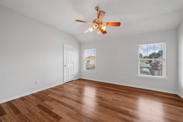 2305 Buckeye Dr, Mesquite, TX 75181 - unfurnished room with a ceiling fan, a textured ceiling, hardwood / wood-style flooring, and lofted ceiling