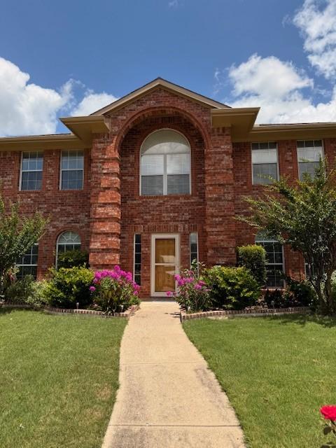 2305 Buckeye Dr, Mesquite, TX 75181 - view of front of home with brick siding and a front lawn