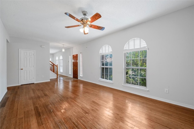 2305 Buckeye Dr, Mesquite, TX 75181 - unfurnished living room featuring healthy amount of natural light, ceiling fan, and hardwood / wood-style floors