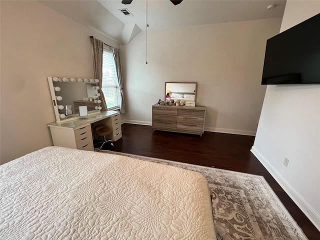 bedroom featuring baseboards, vaulted ceiling, and dark wood finished floors