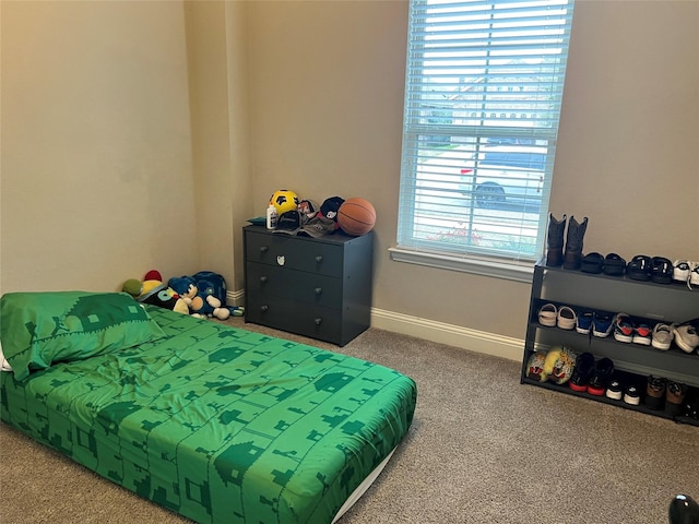 bedroom featuring carpet floors and baseboards