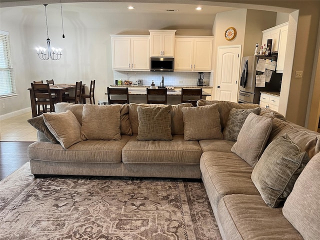 living area with an inviting chandelier, baseboards, dark wood-style flooring, and recessed lighting