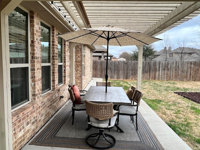 view of patio with outdoor dining area, fence, and a pergola