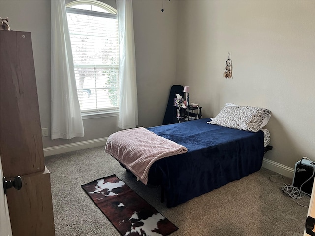 carpeted bedroom featuring baseboards