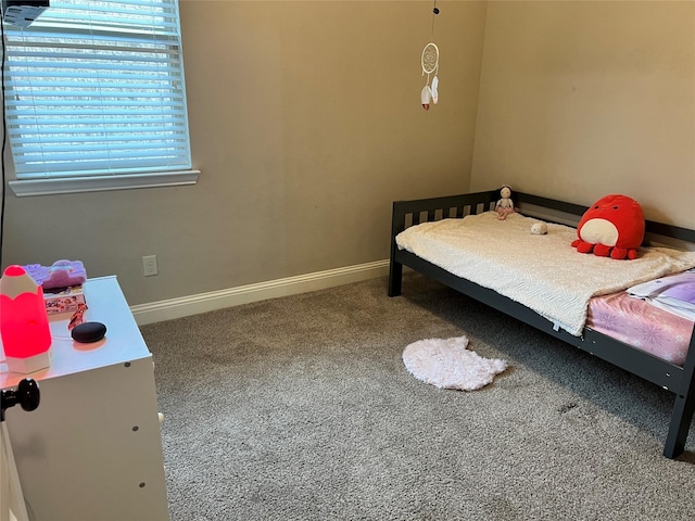 bedroom featuring baseboards and carpet flooring