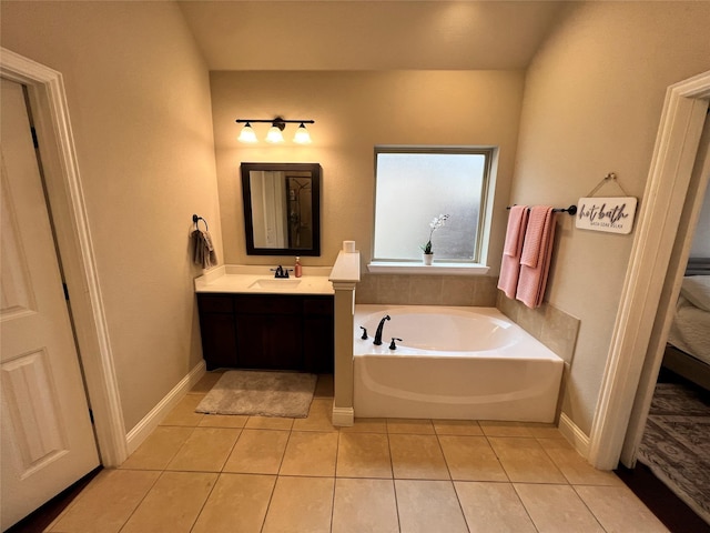 full bathroom featuring baseboards, vanity, a bath, and tile patterned floors