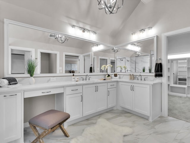 bathroom featuring lofted ceiling, vanity, and a notable chandelier