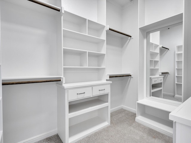 walk in closet featuring light colored carpet