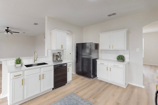 kitchen with white cabinetry, sink, light wood-type flooring, and black appliances