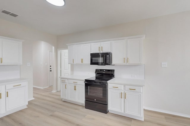 kitchen with tasteful backsplash, black appliances, light hardwood / wood-style floors, and white cabinets