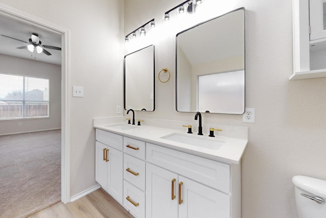 bathroom featuring vanity, hardwood / wood-style floors, toilet, and ceiling fan