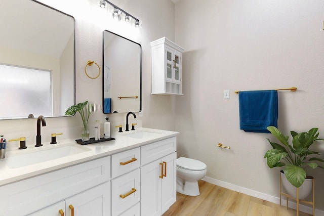 bathroom with vanity, hardwood / wood-style flooring, and toilet