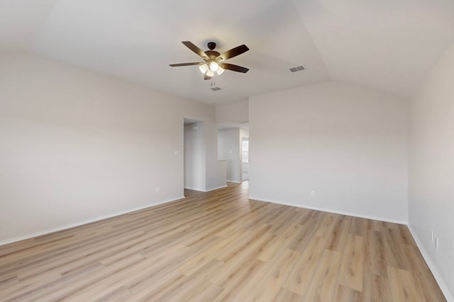 empty room featuring lofted ceiling, ceiling fan, and light hardwood / wood-style flooring