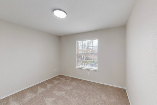 unfurnished room with light carpet