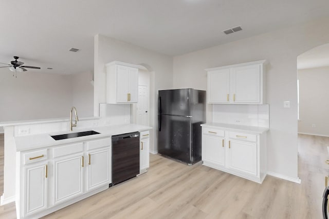 kitchen with white cabinetry, sink, light hardwood / wood-style flooring, and black appliances