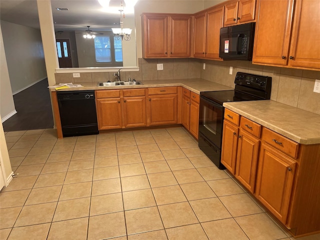 kitchen featuring backsplash, light tile patterned floors, sink, and black appliances