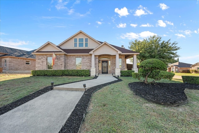 craftsman inspired home with a front lawn