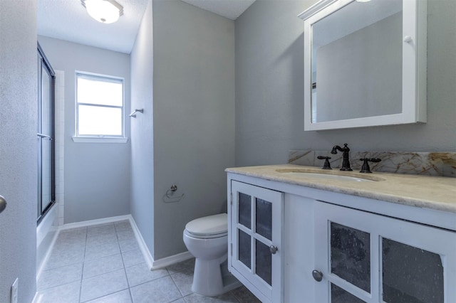 full bathroom with shower / bath combination with glass door, vanity, toilet, and tile patterned flooring