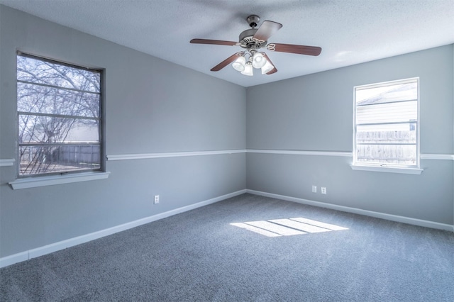 spare room featuring ceiling fan, carpet floors, and a textured ceiling