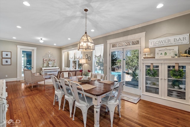 dining area featuring recessed lighting, crown molding, and wood finished floors