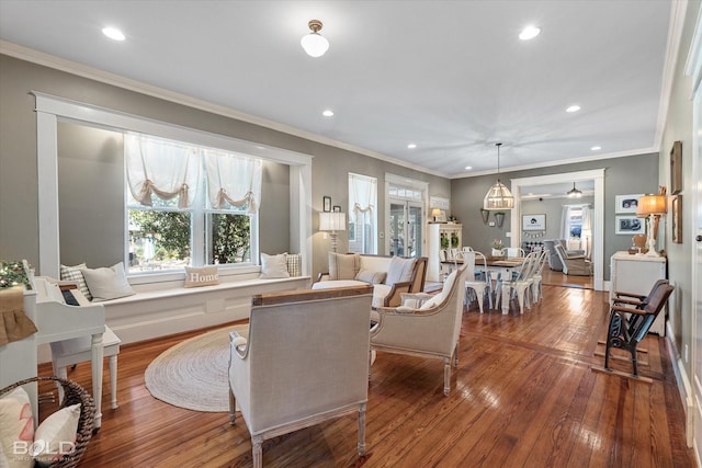 living room featuring ornamental molding, wood finished floors, and recessed lighting