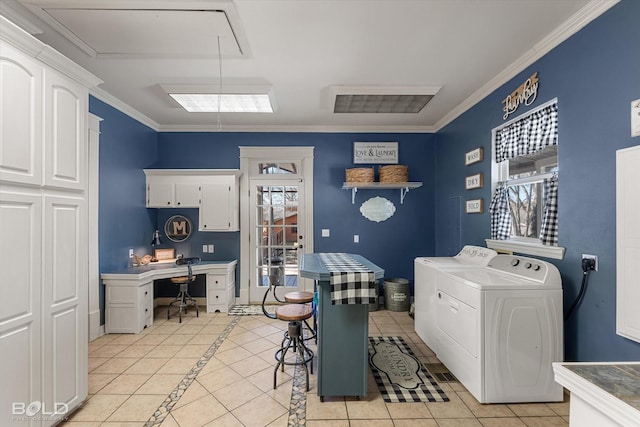 laundry area featuring light tile patterned floors, separate washer and dryer, cabinet space, and attic access