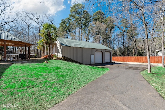 view of outdoor structure with an outbuilding, fence, and a gazebo