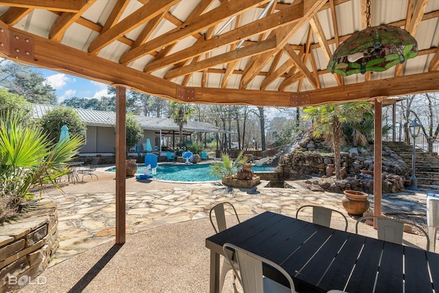 view of patio featuring an outdoor pool and a gazebo