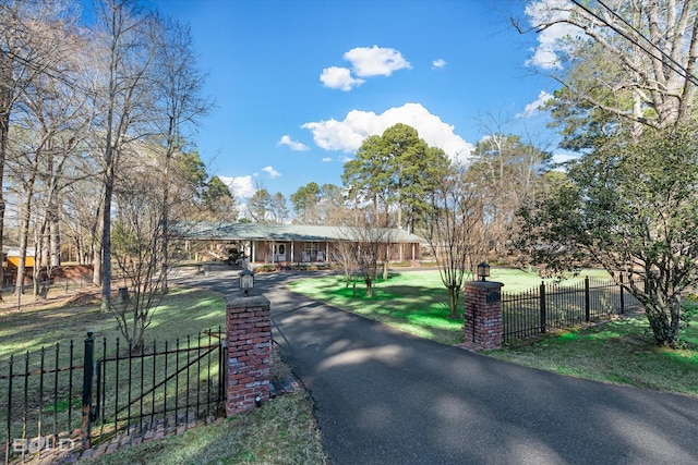 view of front facade with a fenced front yard and a front lawn