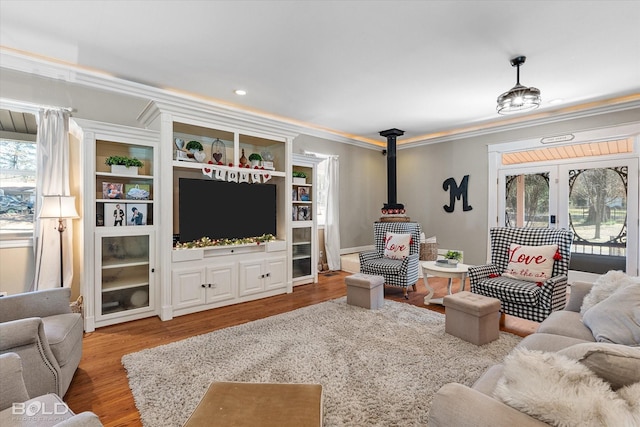 living area with light wood-style floors, french doors, and crown molding