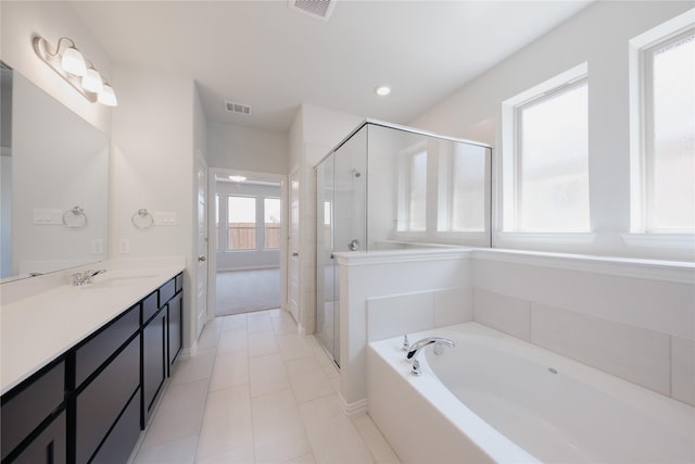 bathroom featuring a bath, a stall shower, vanity, and visible vents