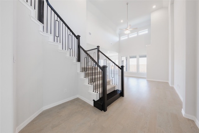 staircase with recessed lighting, baseboards, a ceiling fan, and wood finished floors