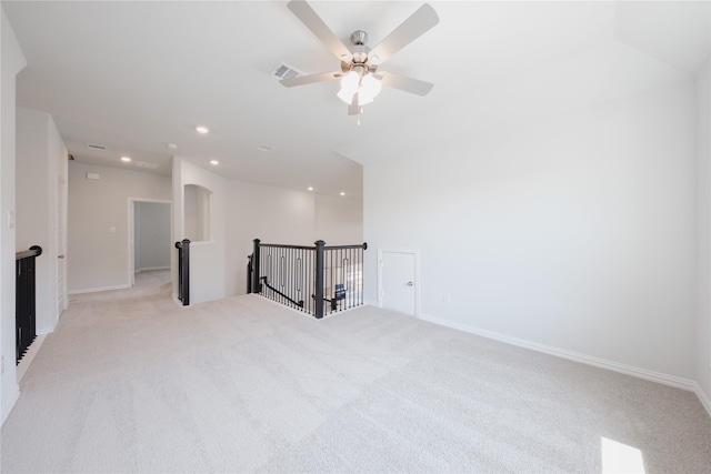 spare room featuring baseboards, recessed lighting, visible vents, ceiling fan, and light colored carpet