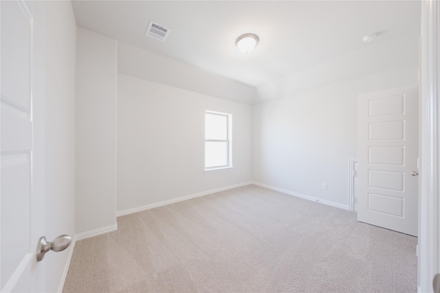 empty room featuring visible vents, baseboards, and carpet