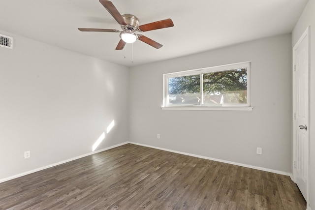 unfurnished room featuring dark wood-type flooring and ceiling fan