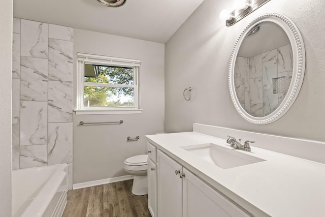 full bathroom featuring wood-type flooring, bathing tub / shower combination, vanity, and toilet