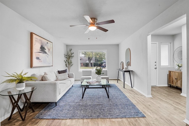 living room featuring ceiling fan and light wood-type flooring