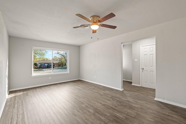 spare room with dark hardwood / wood-style floors and ceiling fan