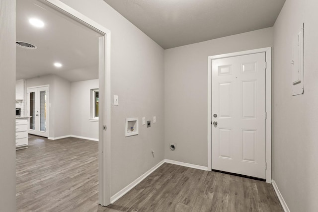 washroom featuring hardwood / wood-style floors, hookup for a washing machine, hookup for an electric dryer, and hookup for a gas dryer