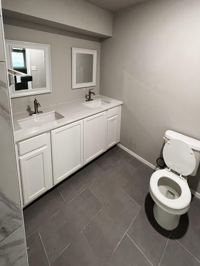 bathroom featuring tile patterned floors, vanity, and toilet