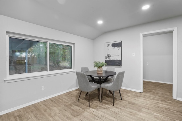 dining area with lofted ceiling and light hardwood / wood-style floors