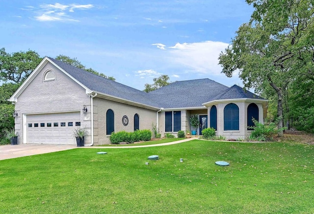 view of front of home with a garage and a front lawn