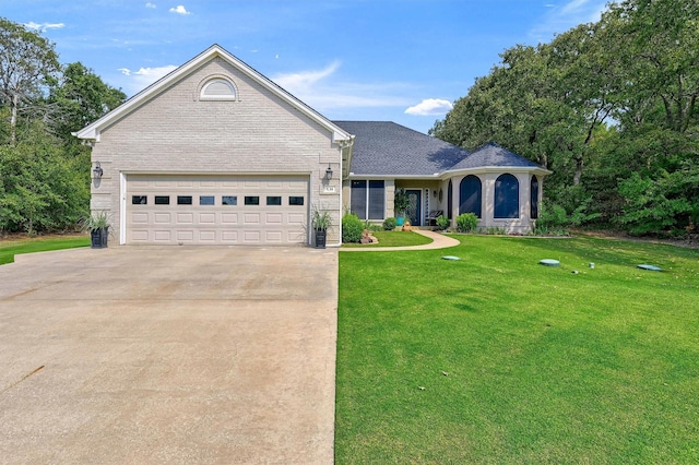 view of front of property featuring a garage and a front lawn